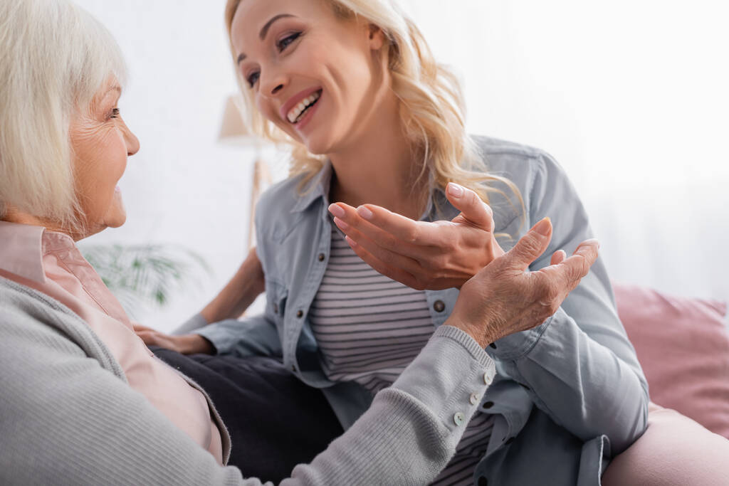 stock-photo-senior-woman-sitting-smiling-daughter